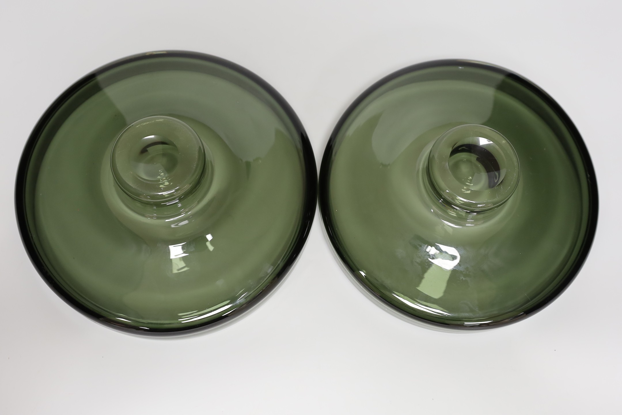 A pair of Scandinavian green glass dishes, 26cms diameter